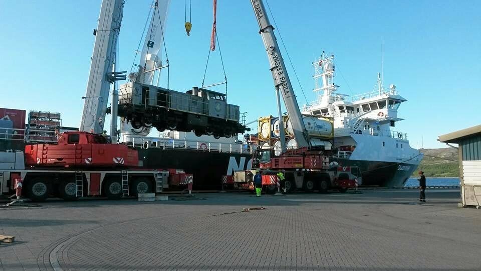 NEDTUR: Det har vært tøffe tider i Kirkenes etter at gruvedriften i Sydvaranger ble lagt ned. Her fraktes lokomotiver som har fraktet malm fra gruven til havna i Kirkenes. Den gamle havna i Kirkenes er ikke verdt å investere mer i, mener myndighetene.Foto: Auksjonen.no