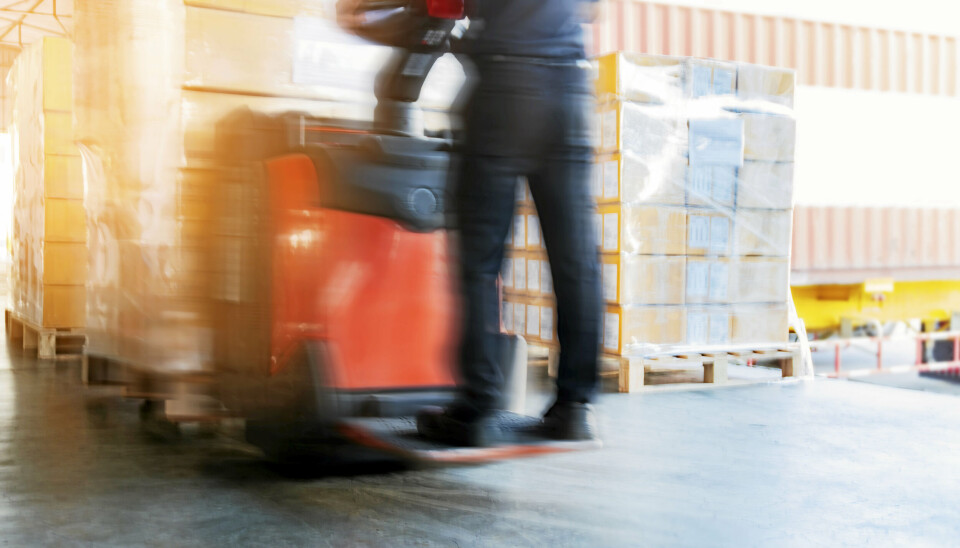 Motion blur of forklift driver unloading cargo pallets at warehouseGaffeltruck. Stttebenstruck. Truck